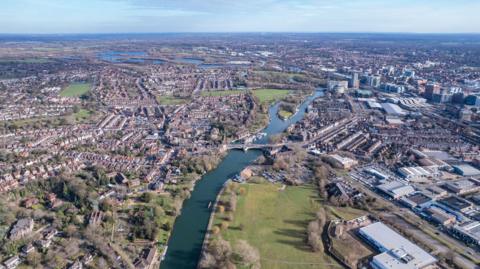 A bird's eye view of Reading with a mix of waterways, green space, industrial buildings and homes
