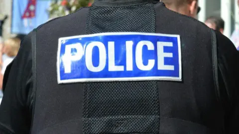 A picture of the back of a anti-stab police vest. There is a blue rectangle box which has the word "police" in white text within it.