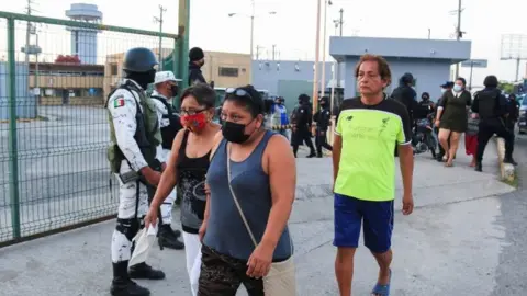 Reuters Relatives of inmates stand outside the penitentiary during a fight among inmates in Villahermosa, in Tabasco state, Mexico June 22, 2021