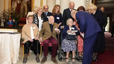 Jordan Pettitt/Getty Images The King with centenarians at Buckingham Palace
