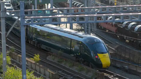 GWR train in green and yellow front on the tracks at Cardiff Central