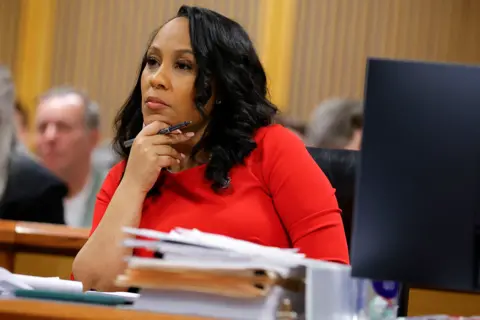 Fani Willis sits in a Georgia courtroom during a hearing about her alleged misconduct 