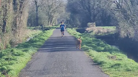 Sarah Szewiel Dylan running with his dog Sam