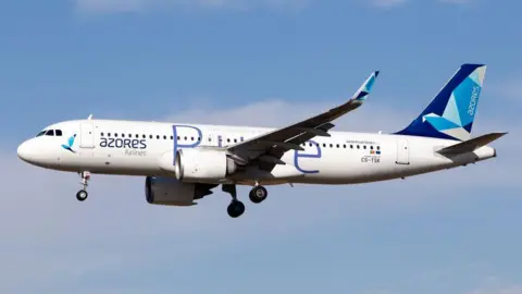 Getty Images Boeing 737 in flight (Azores Airlines with blue sky behind)