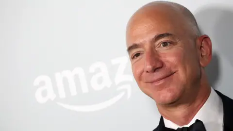 AFP/Getty Jeff Bezos standing in front of an Amazon sign