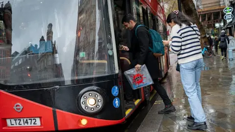 Getty Images People getting on a bus