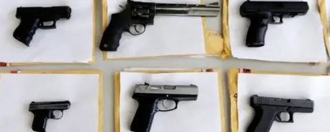 AP Chicago police display some of the thousands of illegal firearms they confiscated during the year in their battle against gun violence in Chicago