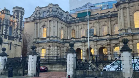 The exterior of Reading Crown Court, a large building with ornate stone columns and arched windows.