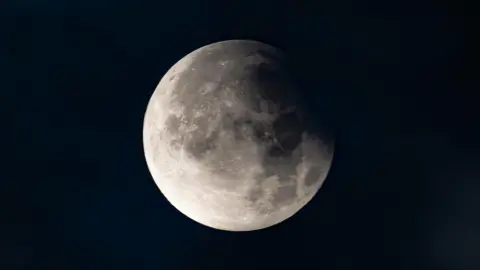 BBC Weather Watchers/Trevca A white, cratered moon in a black night sky.