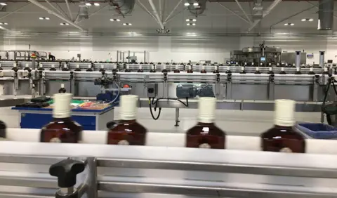 Whisky bottles on a production line at a bottling plant