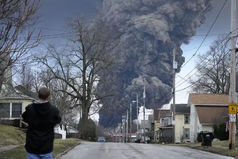 AP A smoke cloud rises above East Palestine after the train derailment