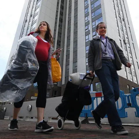 European Photopress Agency Residents leaving the Chalcots Estate in Camden, when the building was briefly evacuated over concerns about fire safety
