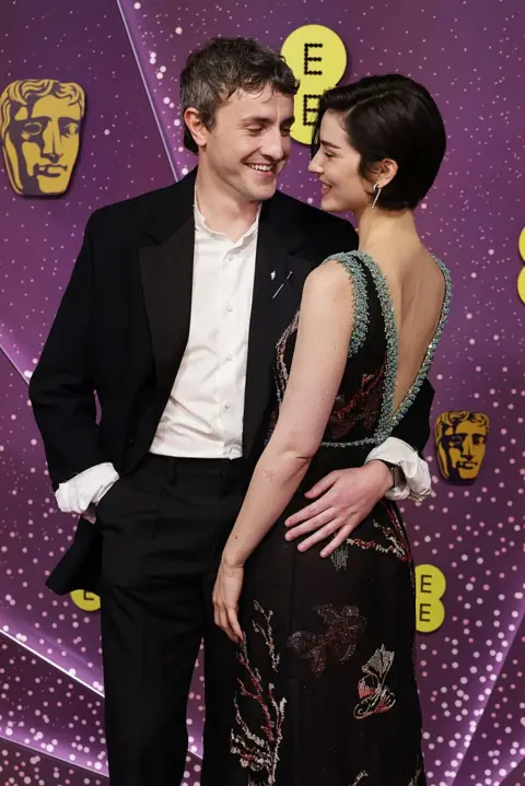 Getty Images Paul Mescal and Gracie Abrams embracing in smart clothes on the red carpet