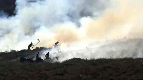 PA Fire crews continue to fight a large wildfire on the moors above Stalybridge