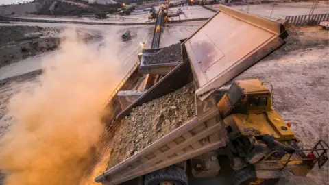 Petra Dump trucks indicating different types of ore needed for correct blending in the processing cycle at Williamson