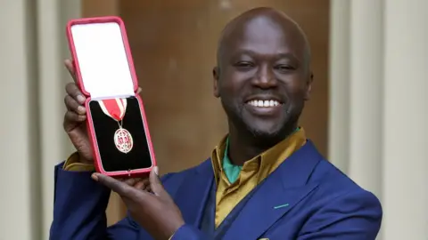 Getty Images Sir David Adjaye poses after he was Knighted by the Duke of Cambridge during an Investiture ceremony at Buckingham Palace on May 12, 2017