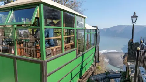 The green cliff railway carriage looking out over the beach below and bay.