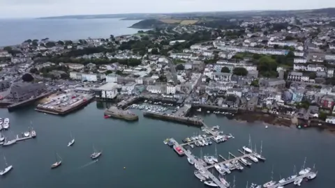 An aerial view of the docks and Falmouth showing parts of the harbour, the docks, boats and buildings. 