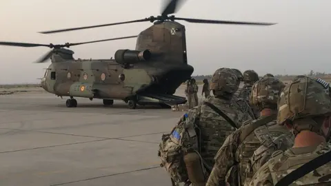 US army US troops walk towards a helicopter