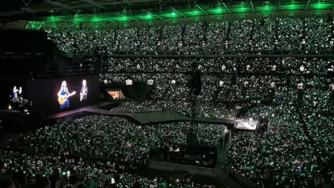 Taylor Swift performing with Ed Sheeran at Wembley Stadium.