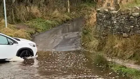 White car stuck in Noyna Ford on Cockhill Lane, Foulridge, Colne