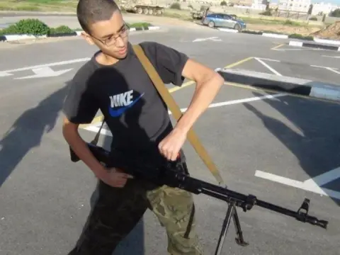 Facebook An image of Hashem Abedi from his father's Facebook page shows him brandishing a large gun