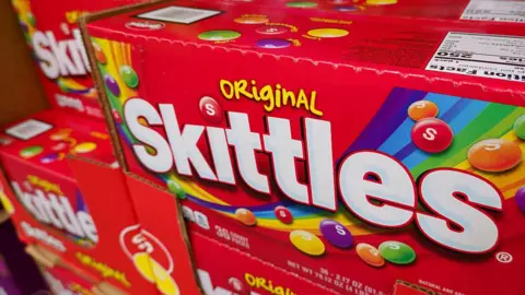 Boxes of Skittles candy are displayed at a Costco Wholesale store on April 27, 2025 in San Diego, California.