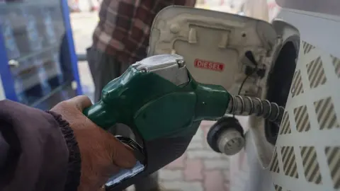 NurPhoto via Getty Images An employee fills the tank of a car with diesel at a Hindustan Petroleum (HP) fuel station in Srinagar, Jammu and Kashmir, on February 02, 2026. 
