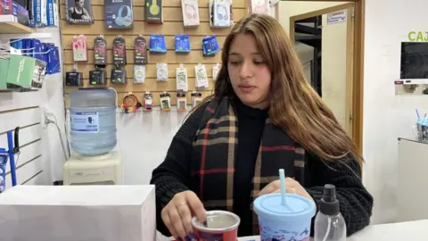 Roberta in the shop she works in