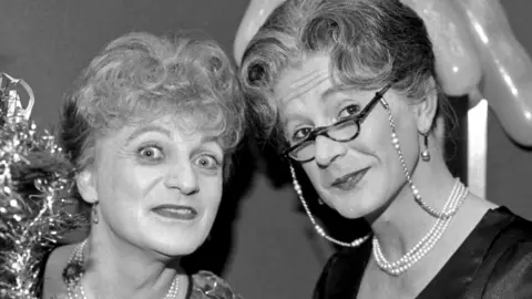 Patrick Fyffe as Dame Hilda Bracket (left) and George Logan as Dr Evadne Hinge (right)