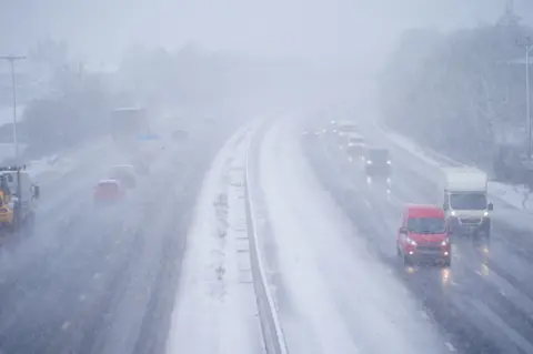 Ben Birchall Motorists drove through heavy snowfall on the M5 near Taunton, Somerset