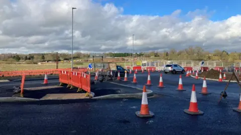 Peter Cooper/BBC Road cones on newly-tarmacked road