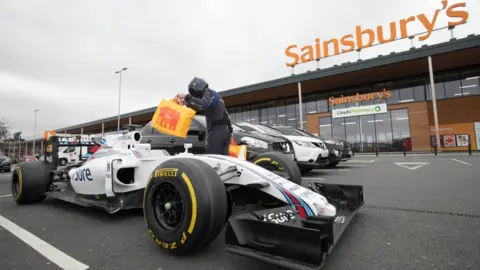 David Parry Williams F1 car in front of Sainsbury's