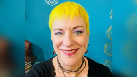 Emma King Picture of lady with yellow hair and blue background