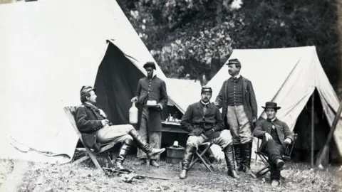 Getty Images A black orderly serves drinks to Union officers during the Civil War