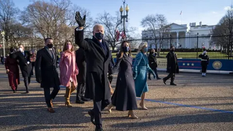 EPA US President Joe Biden and First Lady Jill Biden walk along Pennsylvania Avenue in front of the White House, in Washington, DC, 20 January 2021