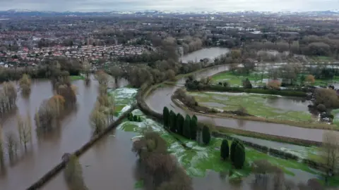 PA Media aerial view of Manchester with floodwaters and snow