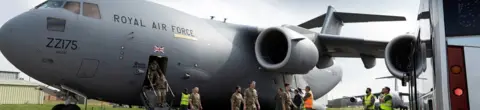 Reuters Military personnel arrive at RAF Brize Norton base after being evacuated from Afghanistan