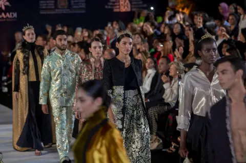 Jalal Morchidi/EPA Models process down the catwalk in creations by Moroccan designer Fadila El Gadi in Rabat, Morocco - Tuesday 30 May 2023
