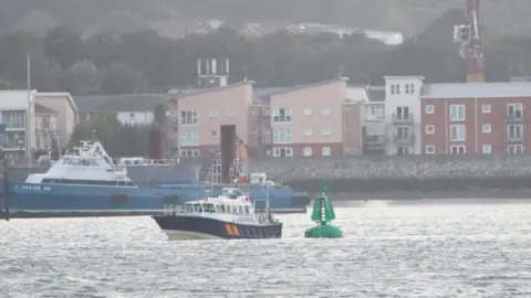 PA Media Southampton Harbour Master launch inspecting a buoy off Hythe, Hampshire