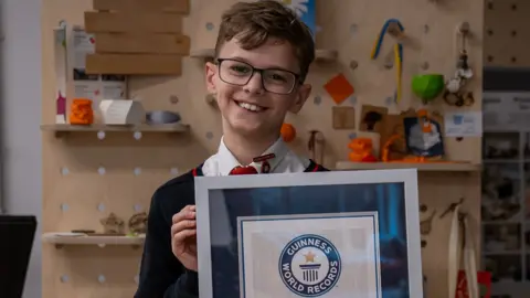 Max holding his certificate 