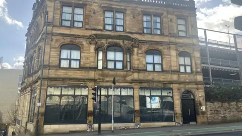 Exterior view of a stone shop front in a city centre .