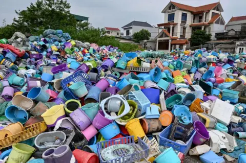  NHAC NGUYEN/AFP Piles of plastic waste are pictured at a recycling site next to a residential area on the outskirts in Hanoi, Vietnam on September 17, 2024. 