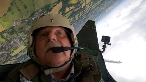 Man in Spitfire cockpit