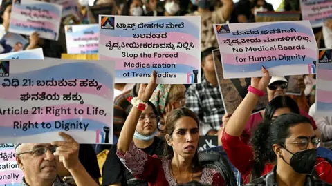 AFP via Getty Images Activists and members of the transgender community hold placards during a protest against the proposed Transgender Persons (Protection of Rights) Amendment Bill at the Freedom Park in Bengaluru on March 18, 2026.