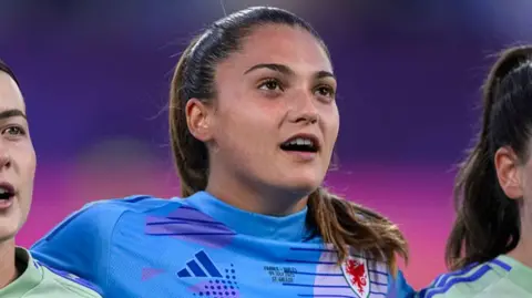 Wales goalkeeper Safia Middleton-Patel sings the national anthem ahead of her major tournament debut against France in St Gallen, Switzerland