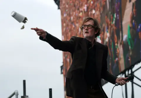 EPA Jarvis Cocker throws a paper cup full of tea bags into the audience at the Glastonbury festival