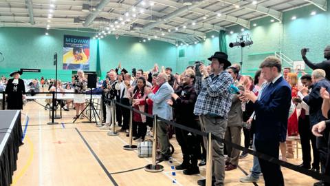 People celebrate at the Medway election count for Gillingham and Rainham
