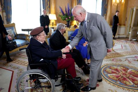 King Charles shaking hands with D-Day veterans