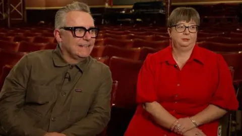 Darren Johnson and Sarah Shooter are sat inside the auditorium of Wakefield's Theatre Royal